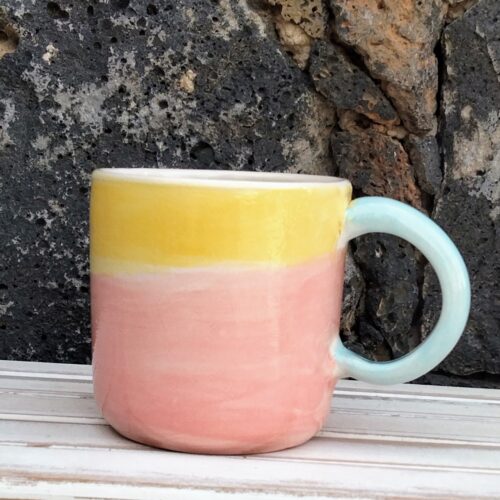 pink and yellow ceramic mug